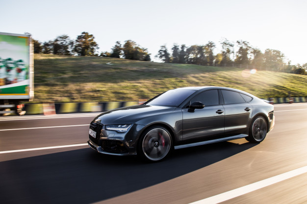 grey luxury sedan car driving