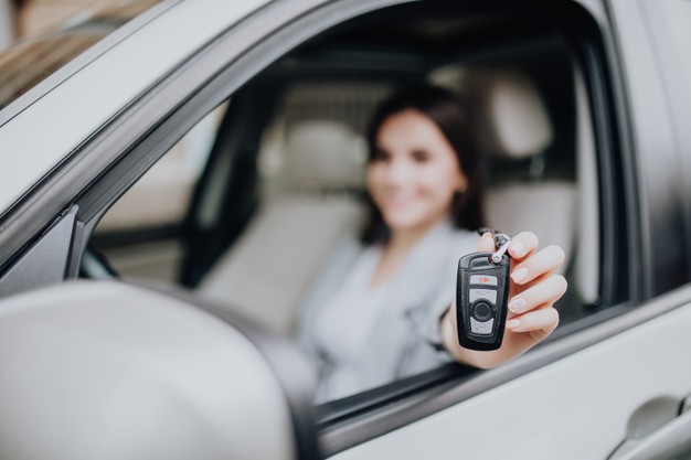 young happy-woman near car with keys